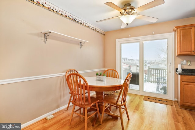 dining area with light wood-type flooring and ceiling fan