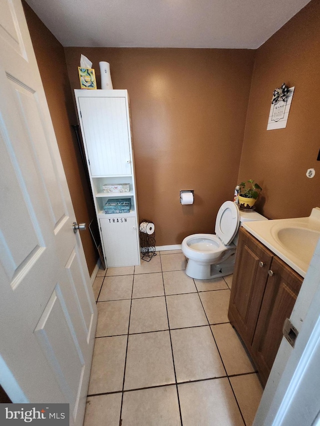 bathroom featuring tile patterned flooring, vanity, and toilet