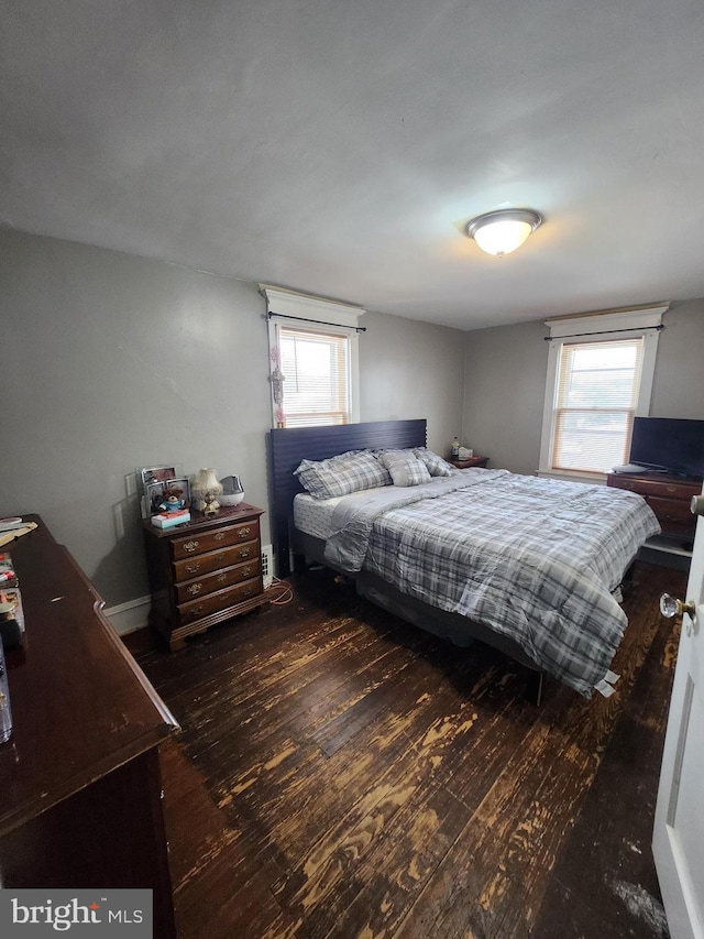 bedroom with dark wood-type flooring