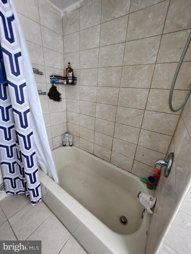 bathroom with tile patterned floors and shower / bathtub combination with curtain