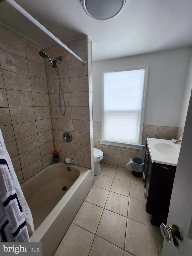 full bathroom featuring tile patterned floors, shower / bath combo with shower curtain, vanity, and toilet