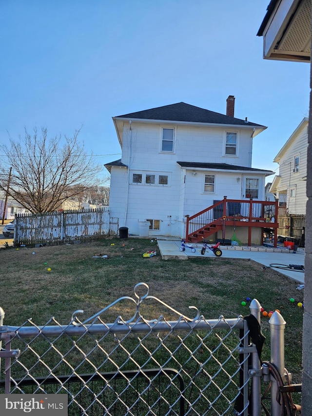 back of property featuring a yard, a patio, and a wooden deck