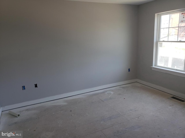 unfurnished room featuring plenty of natural light