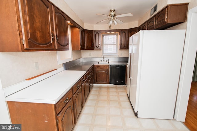 kitchen featuring dark brown cabinetry, ceiling fan, dishwasher, sink, and white refrigerator