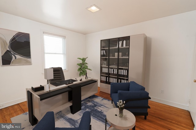 home office with hardwood / wood-style floors