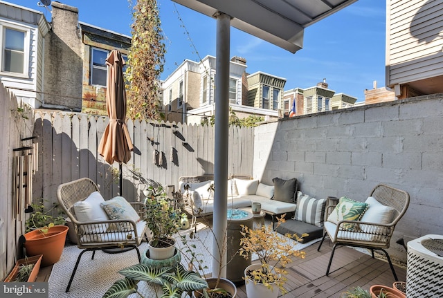 view of patio with an outdoor living space, cooling unit, and a deck