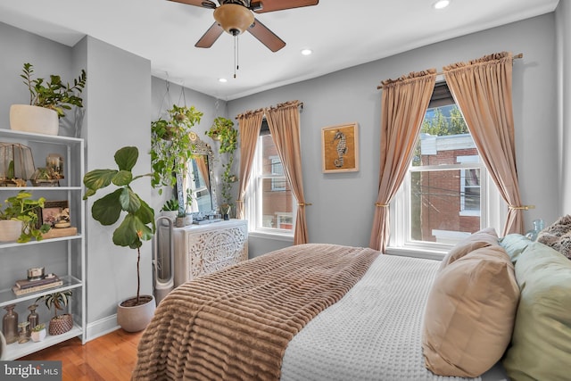 bedroom with ceiling fan and light wood-type flooring