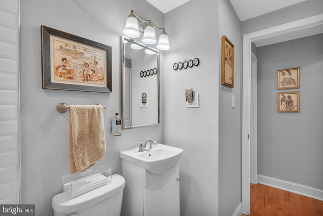 bathroom featuring hardwood / wood-style floors, toilet, and sink