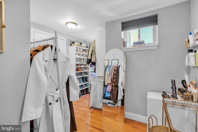 walk in closet with wood-type flooring