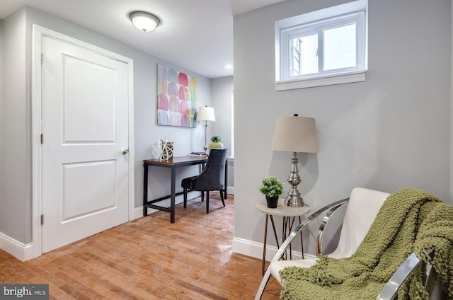 living area with hardwood / wood-style floors