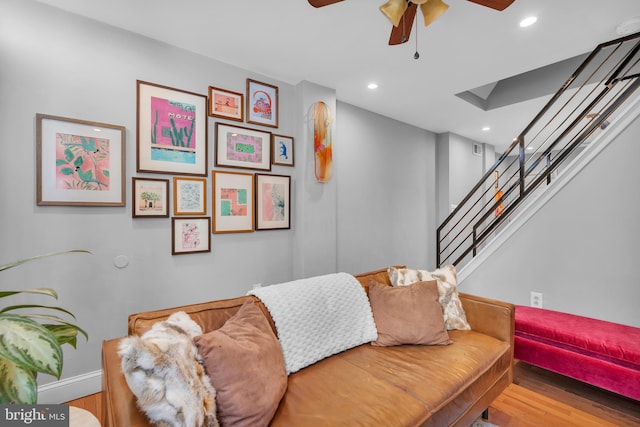 living room featuring hardwood / wood-style floors and ceiling fan