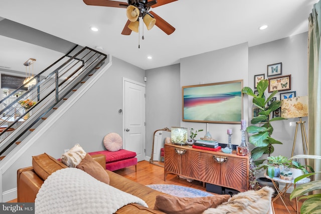 living room with ceiling fan and light hardwood / wood-style flooring