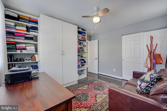 interior space featuring ceiling fan and dark wood-type flooring