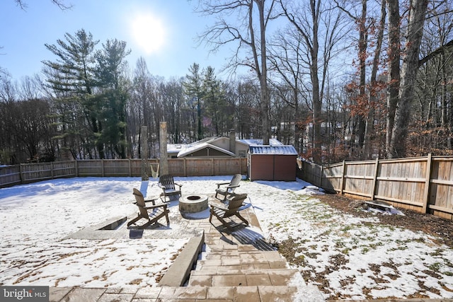 snowy yard featuring an outdoor fire pit