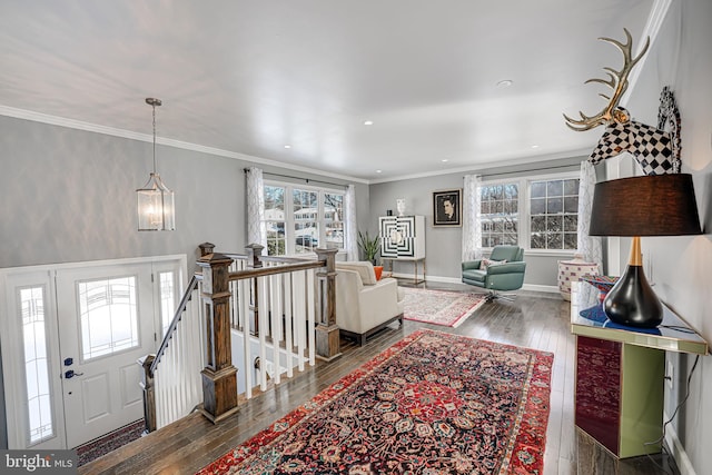 living room with a chandelier, a wealth of natural light, crown molding, and dark hardwood / wood-style floors