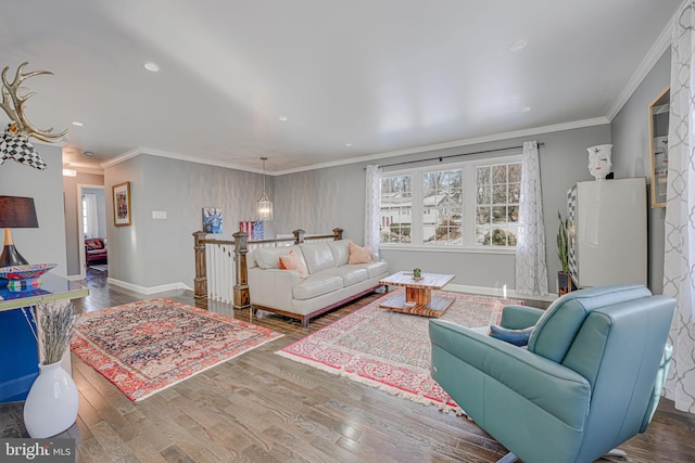 living room featuring hardwood / wood-style flooring and ornamental molding