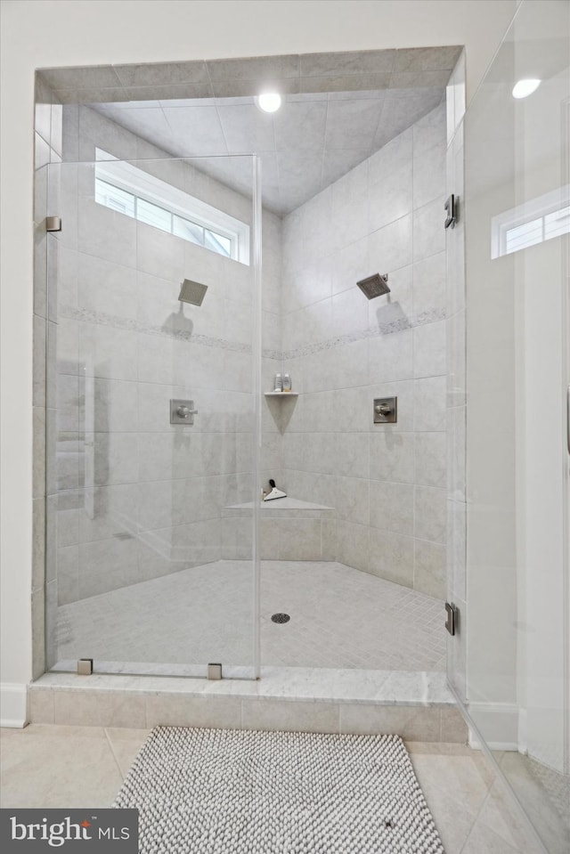 bathroom featuring tile patterned flooring and a shower with door