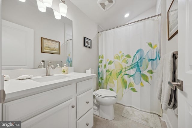 bathroom featuring tile patterned flooring, vanity, toilet, and lofted ceiling