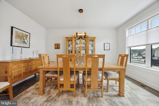 dining space featuring hardwood / wood-style floors and a healthy amount of sunlight