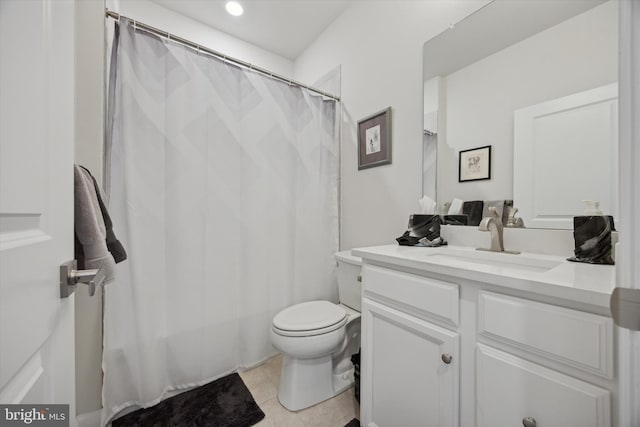 bathroom featuring tile patterned flooring, vanity, and toilet