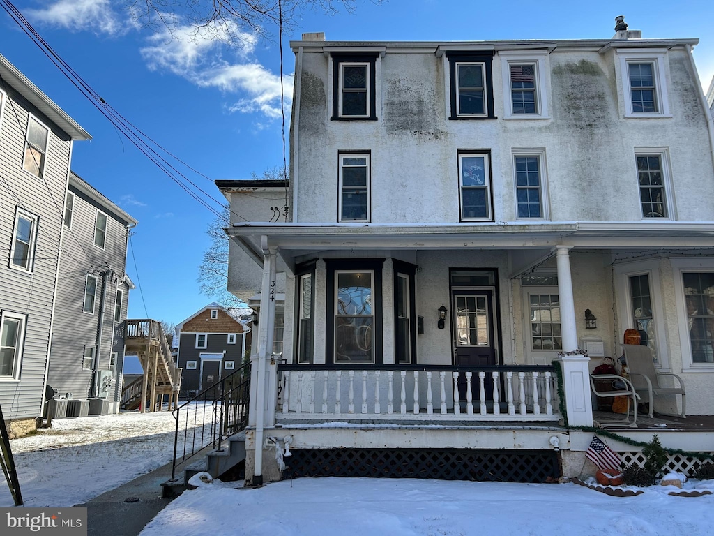 view of front of property with covered porch and central AC