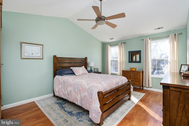 bedroom featuring ceiling fan, hardwood / wood-style floors, and lofted ceiling