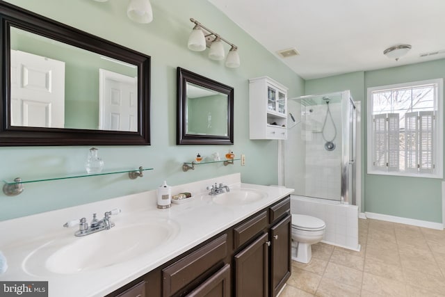 bathroom featuring walk in shower, vanity, tile patterned flooring, and toilet