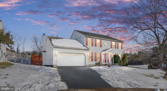 colonial inspired home featuring a garage