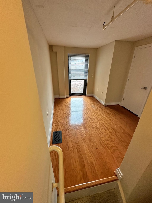 unfurnished room with light wood-type flooring