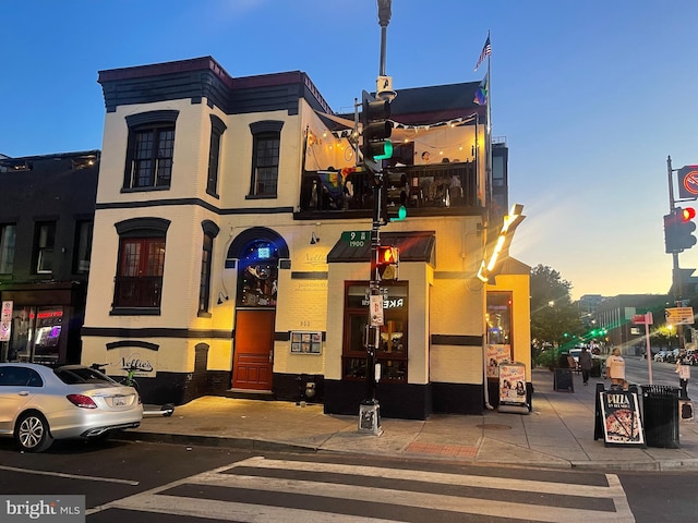 view of outdoor building at dusk