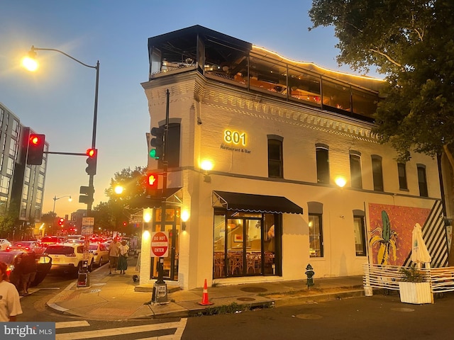 view of outdoor building at dusk