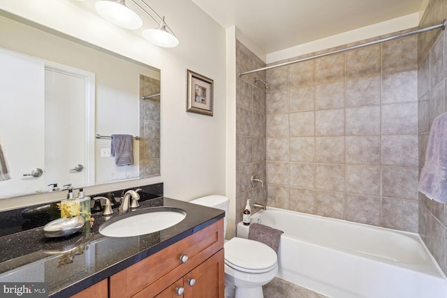 full bathroom with vanity, toilet, and tiled shower / bath