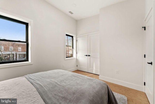 bedroom with a closet and light hardwood / wood-style flooring