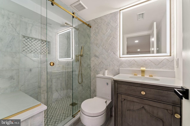 bathroom with vanity, toilet, a shower with door, and decorative backsplash