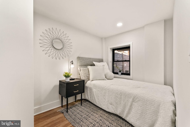 bedroom with hardwood / wood-style flooring