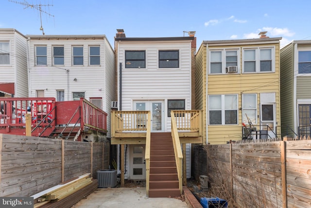 back of house with central AC unit and a deck