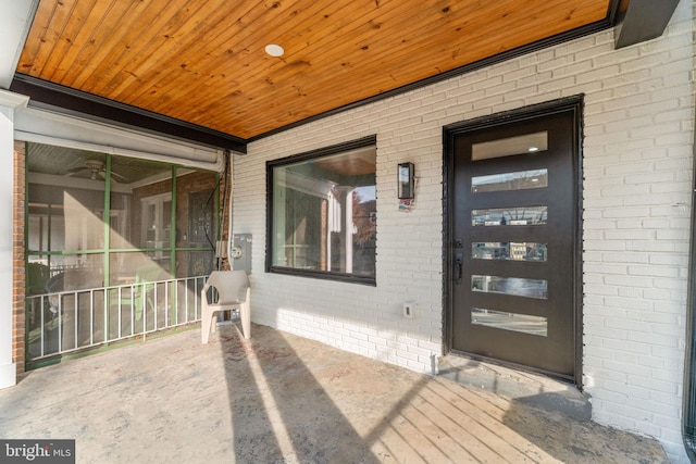 doorway to property featuring ceiling fan