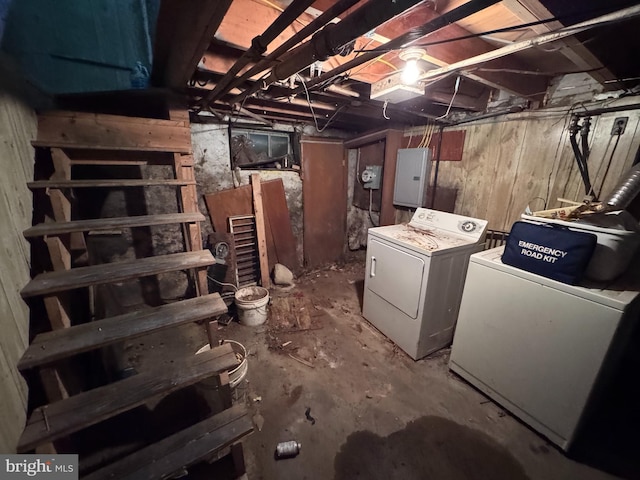 basement featuring washing machine and dryer and electric panel