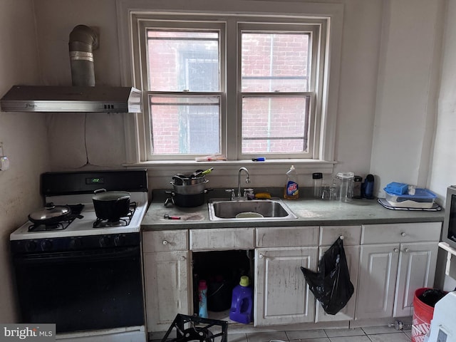 kitchen featuring white cabinets, sink, range hood, light tile patterned flooring, and white range with gas stovetop