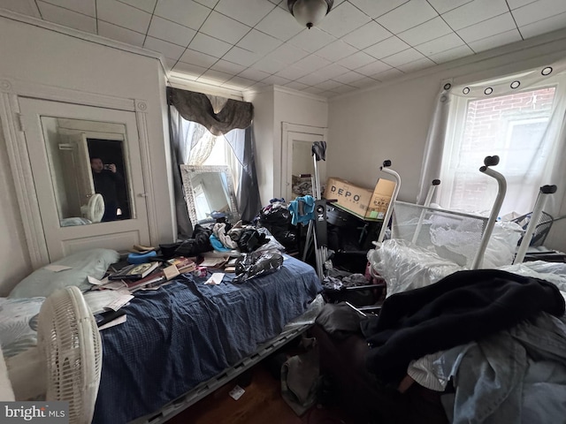 bedroom with hardwood / wood-style floors and crown molding