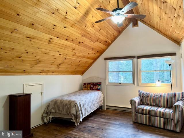 bedroom with vaulted ceiling with beams, ceiling fan, dark hardwood / wood-style floors, a baseboard radiator, and wood ceiling