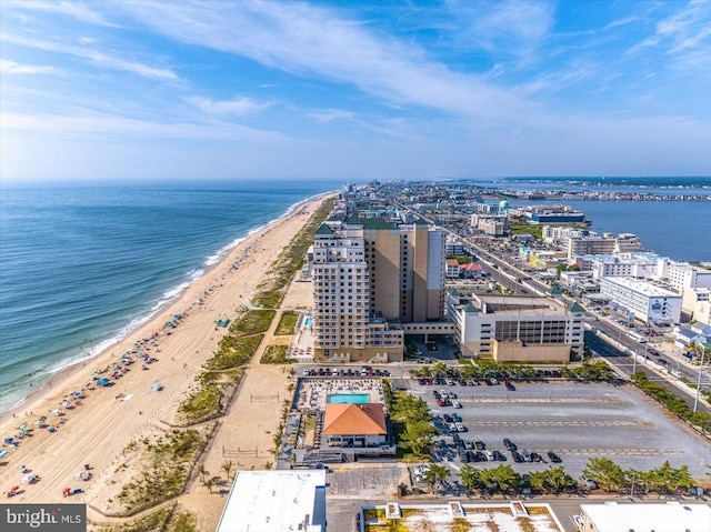 drone / aerial view featuring a view of the beach and a water view