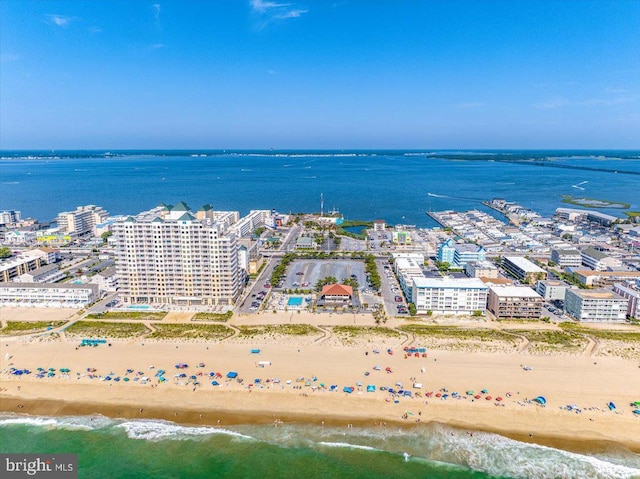 drone / aerial view featuring a water view and a beach view