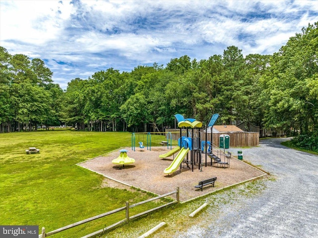 view of jungle gym featuring a lawn