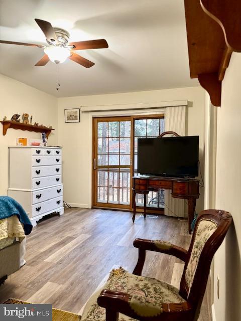 sitting room with ceiling fan and light hardwood / wood-style floors