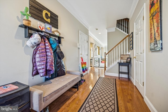 mudroom with ornamental molding and hardwood / wood-style floors