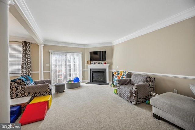 living room with decorative columns, crown molding, and carpet floors