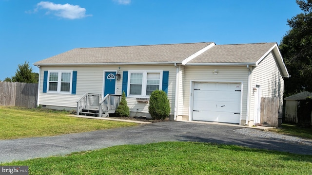 single story home featuring a front yard and a garage