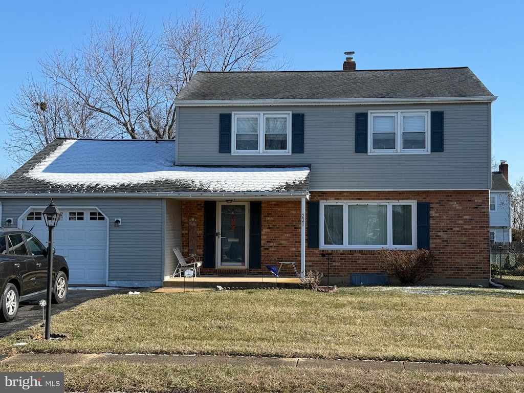 front of property featuring a garage and a front yard