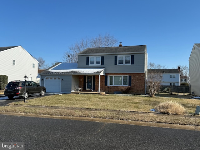 front of property with a front lawn and a garage